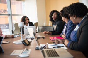 woman sitting around a conference table